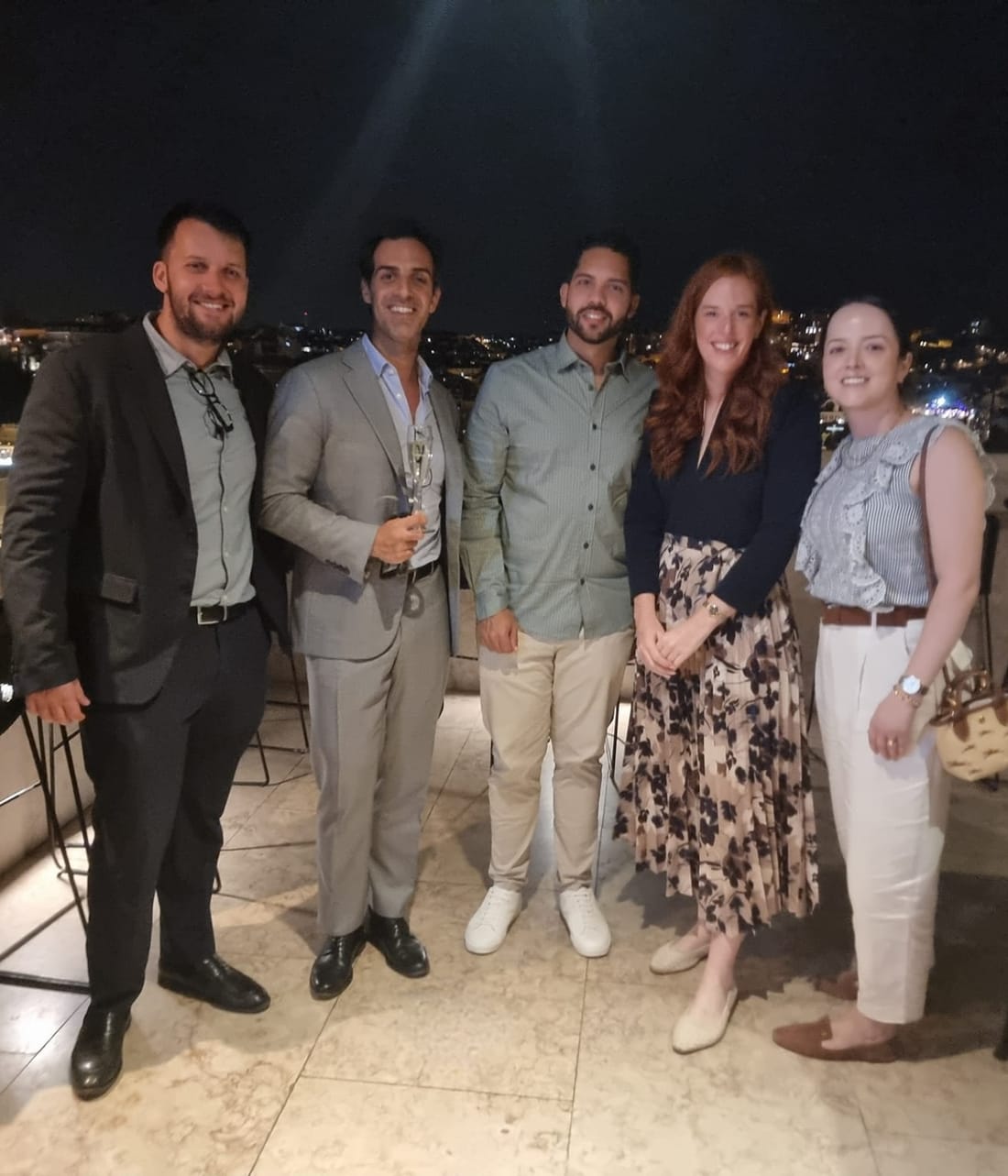 Viv Europe clients and team together at an evening rooftop get-together